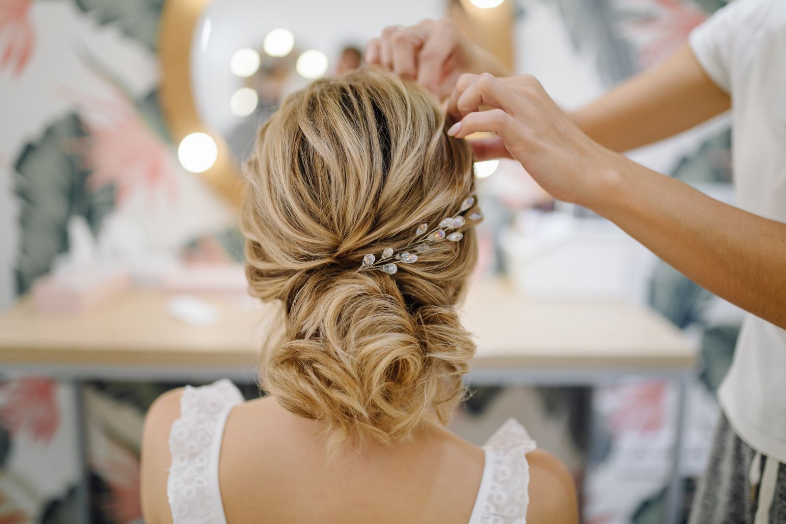 A bride getting her hair ready by a hairdresser in Ibiza