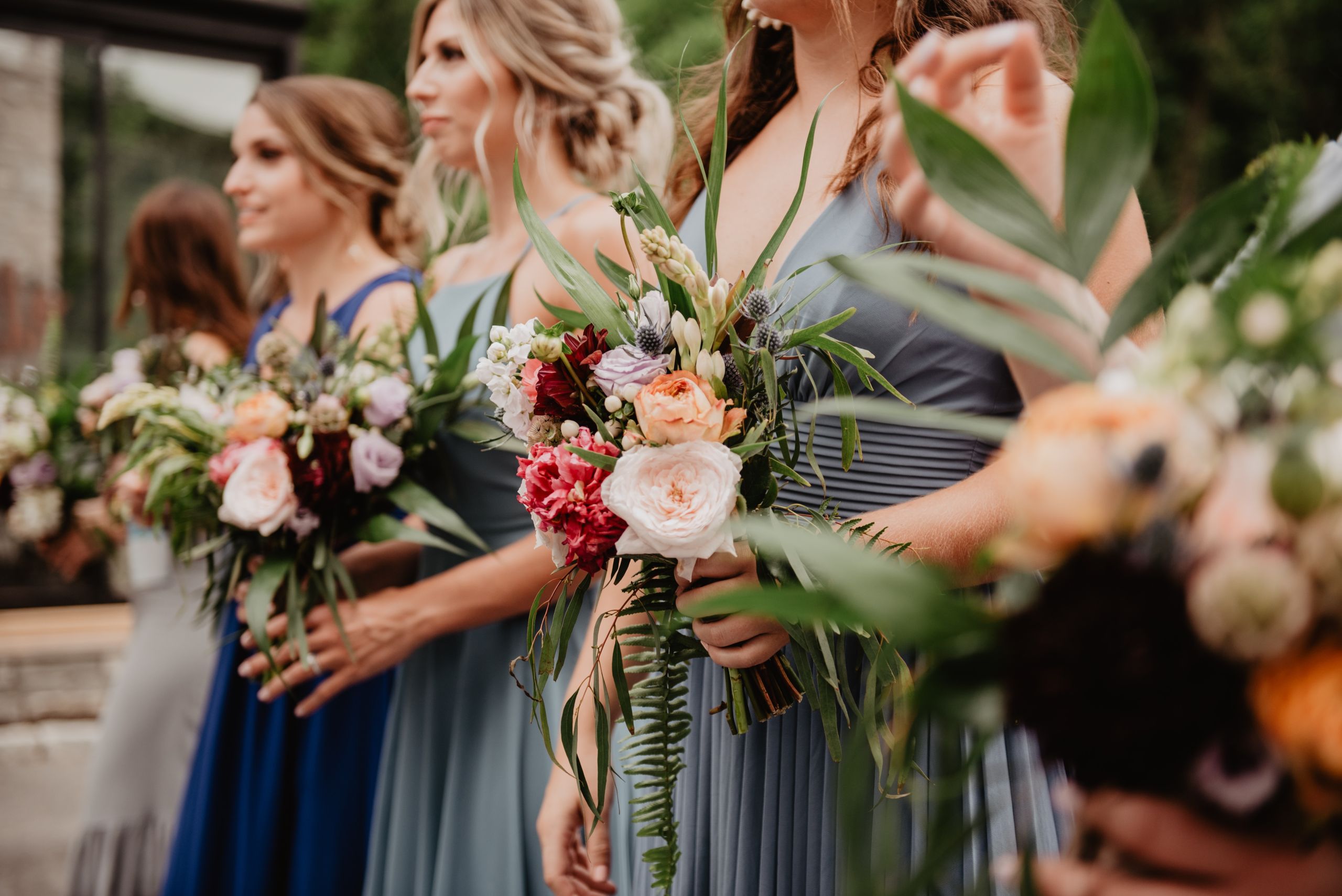 Photography of a group of friends holding wedding bouquets